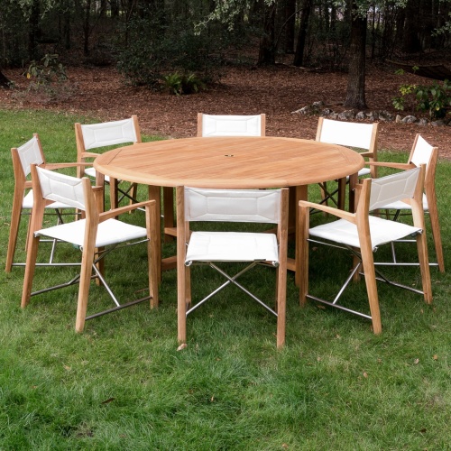 70456 Odyssey Buckingham 9 piece Dining Set on grass field with trees and brown mulch in background