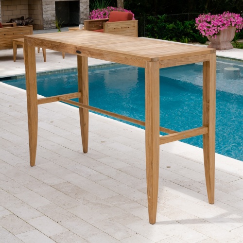 70501 Laguna 5 piece Teak High Bar Set on patio pavers by pool with fireplace and two teak craftsman chairs in background