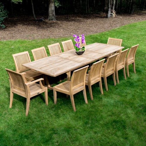 70885 Laguna Side Chairs and Arm Chairs with Veranda Extension Table on grass lawn with trees and mulch in background