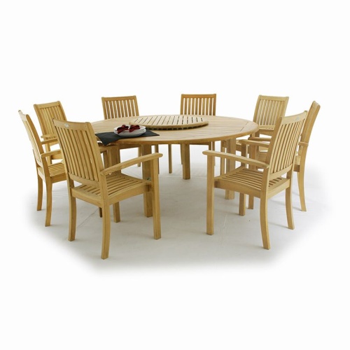 70154 Buckingham teak 9 piece round Dining Set with stack of white plates and cloth napkins and optional teak lazy susan on table in white background