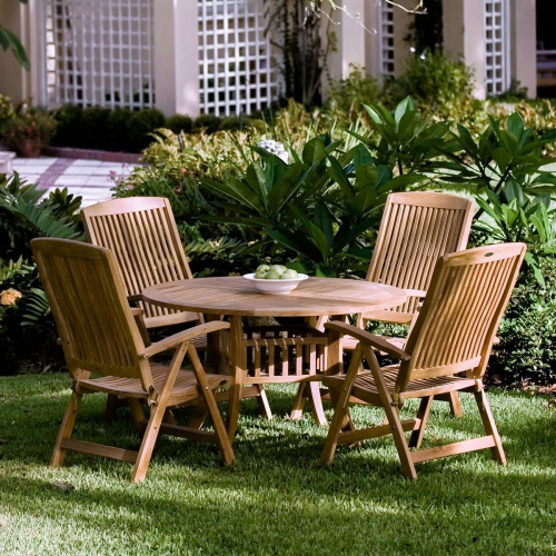 12589S Barbuda Recliners and Teak table on grass lawn with landscape shrubs and house in background