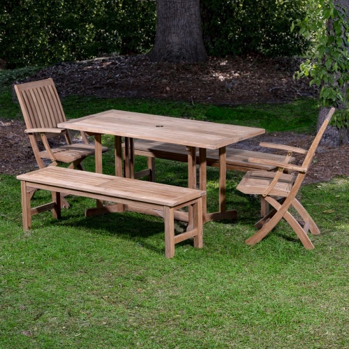 70061 Barbuda teak 5 foot long Picnic Table of 2 folding armchairs and 2 backless 5 foot benches on grass lawn with trees and shrubs in background