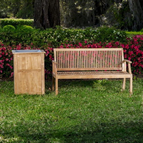 13811 laguna five foot long teak bench on grass in fieldwith trash receptacle left side and flowers in background