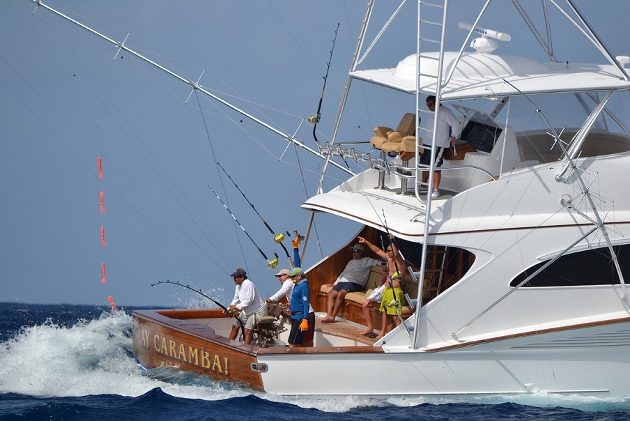 An image of Release Marine fishing boat named Ay Caramba side view with people fishing on the ocean.