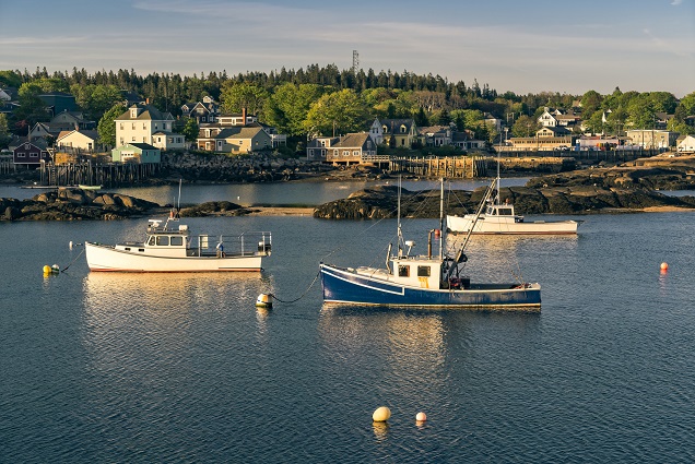 An image of 3 fishing boats moored in Stonington, Maine.