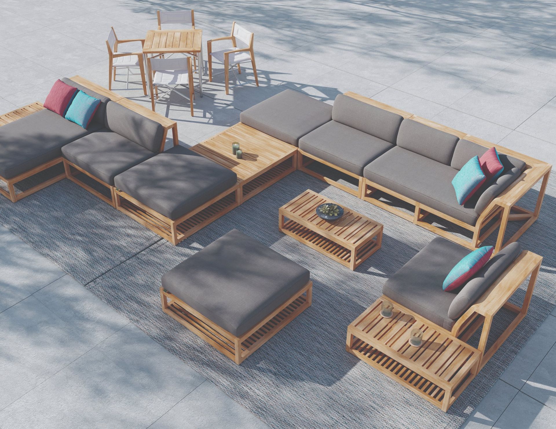 Maya modular teak sectional on a sunlit stone terrace