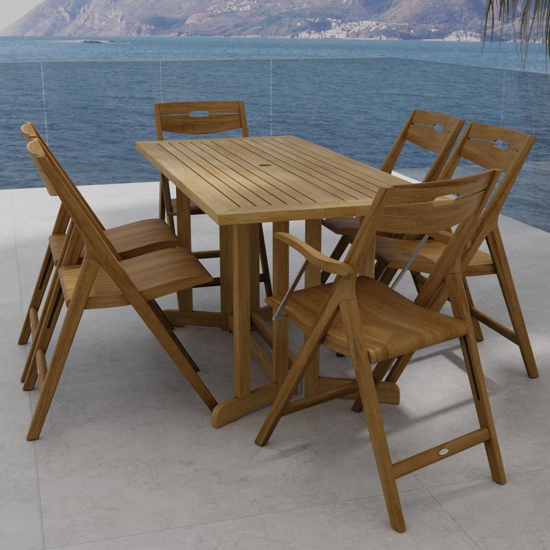 alt="70146 Surf Nevis Teak 7 pc Dining Set of Nevis Dining Table and 2 Surf Dining Chairs and 4 Surf Side Chairs angled end view on tile patio overlooking the ocean and land mass in background"