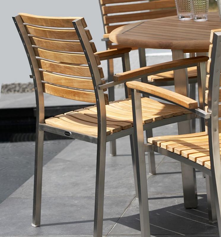 alt="22007ST Vogue Dining Chair closeup of back side of armchair on concrete patio"