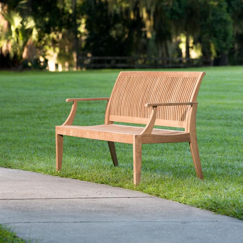 alt="13812 Laguna 5 foot long Teak Bench on grass park with walkway in front and trees in background"