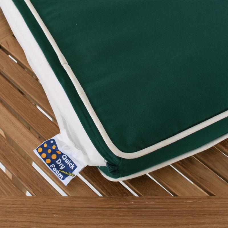 alt="71021MTO armchair cushion in forest green lying on a table"