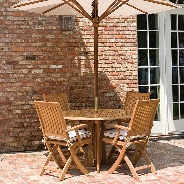 alt="70066 Barbuda Round 5 piece Folding Dining Set on brick patio with house and french patio doors in background"