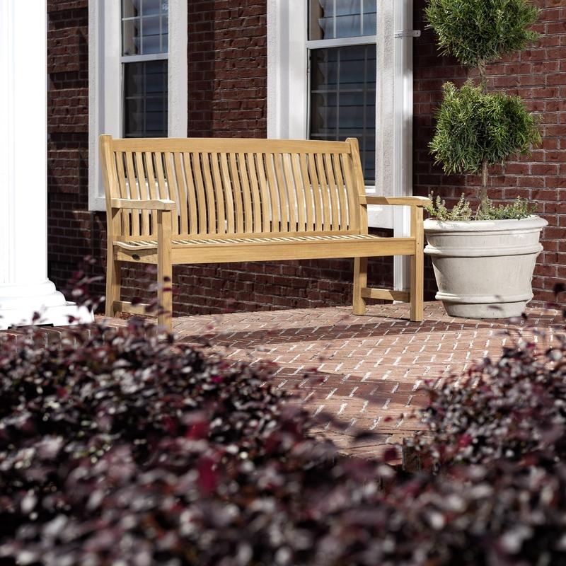 alt="13618 Veranda Teak 5 foot long Bench on concrete stone patio with house windows in background"