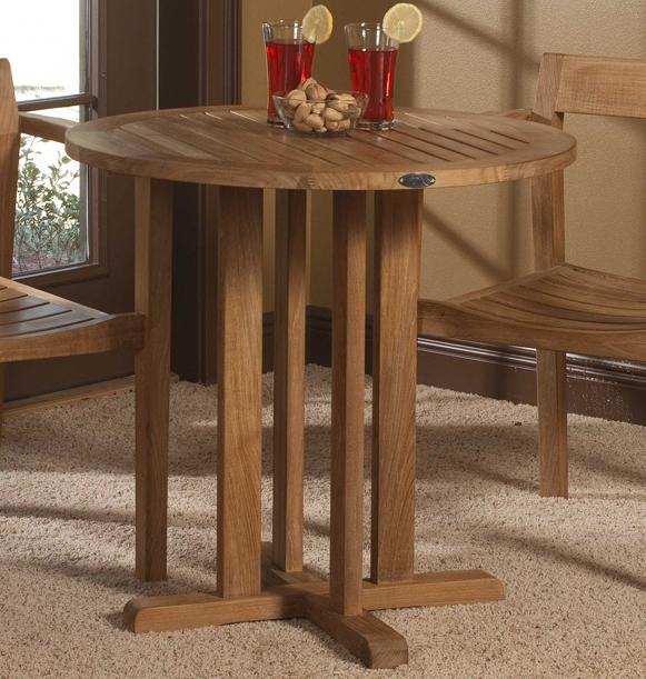 alt="15771 Teak 30 inch round Bistro Table with 2 ice tea glasses and bowl of snacks on table indoors on carpet with french door in background"