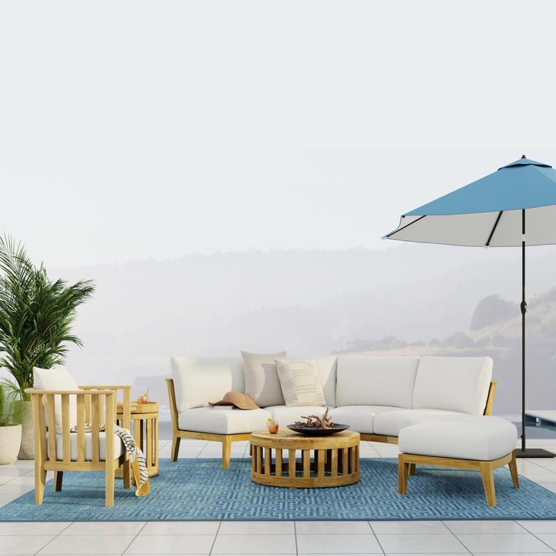 alt="70940 Kafelonia 6 piece Sofa Sectional Set in side view on outdoor terrace one side lined with 2 potted plants next to optional opened blue umbrella with fog and hills in background"