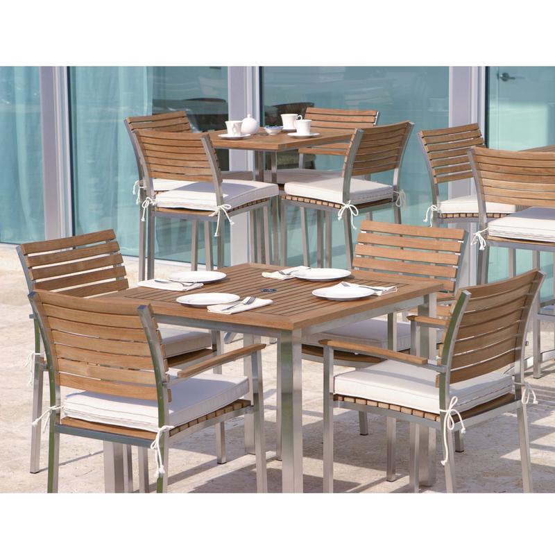 alt="25190 Vogue Bistro teak and stainless steel 36 inch Square Table with 5 piece Vogue Dining Set with vogue bar set and glass patio doors in background"