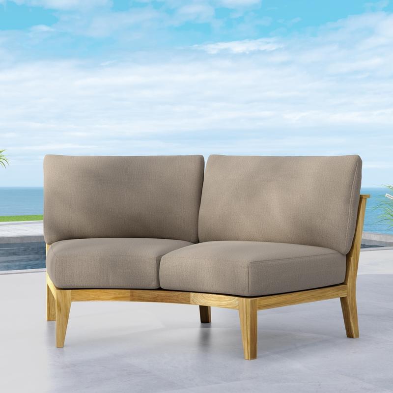 alt="13343DP Kafelonia Sofa Sectional with optional cushions angled front view on outdoor patio with ocean and blue sky background background"