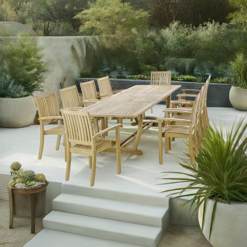 alt="70758 Sussex Veranda 11 piece teak dining set of 10 teak dining armchairs and rectangular dining table end view on white terraced patio with potted and landscaping plants in background"