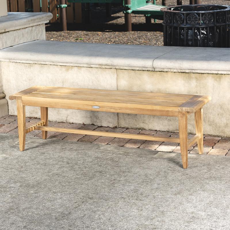alt="13916 Laguna Teak 5 foot Backless Bench angled view on concrete stone patio with concrete low wall in background"