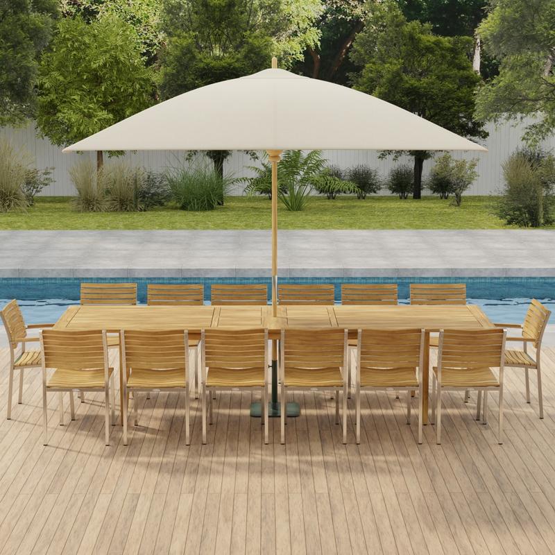 alt="70352 Laguna Vogue 15 piece teak Dining Set of 14 dining armchair and rectangular 11 foot extendable dining table with optional umbrella in side angled view on pavers with pool in background"