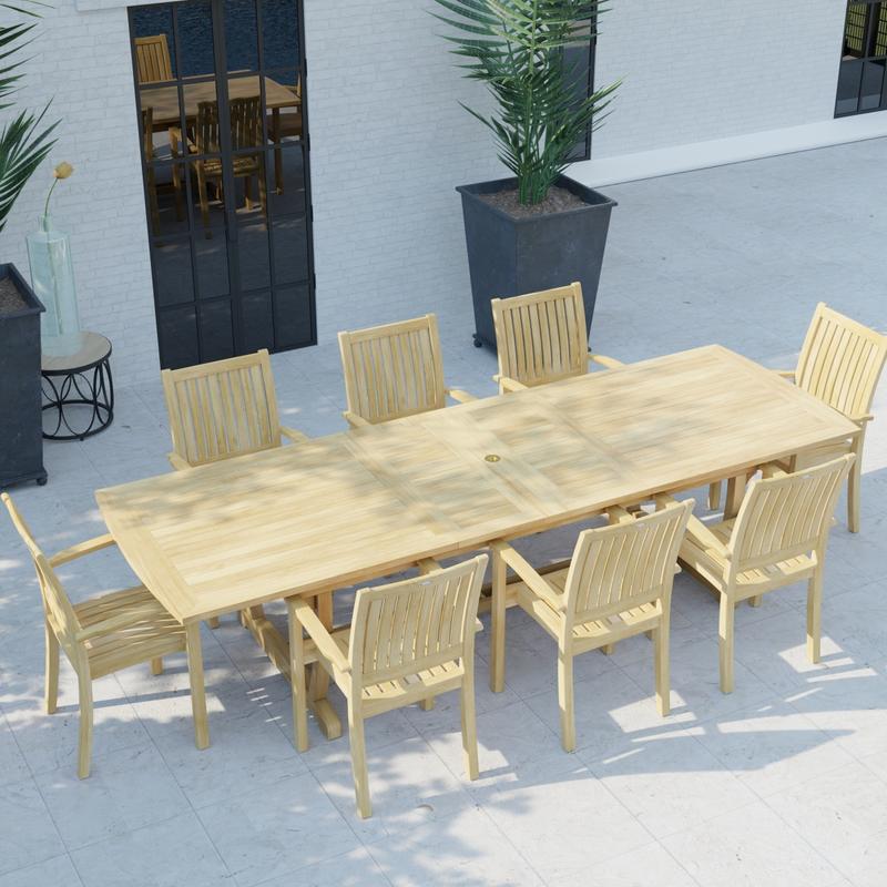 alt="70759 Sussex Veranda 9 pc Teak Patio Dining Set of Sussex Dining Table and 8 Veranda Dining Chairs in angled aerial view on pool deck with house and windows and 2 potted plants in background "