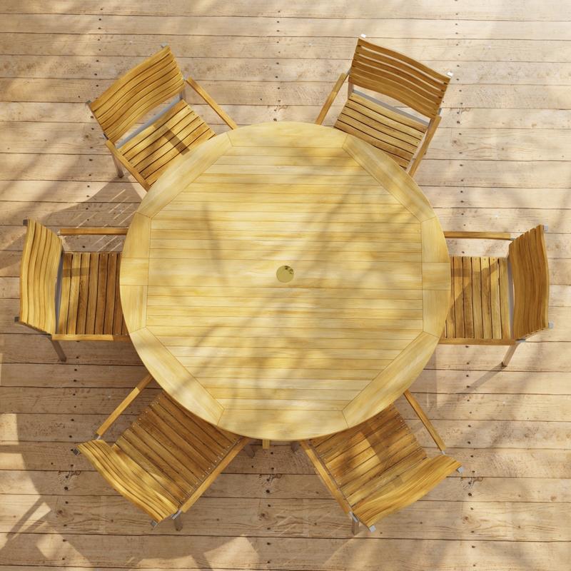 alt="70349 Barbuda Vogue Teak 7 pc Dining Set showing Barbuda 60 inch round DIning Table and 6 Vogue Teak and Stainless Steel  Stacking Armchairs in aerial view on paver patio "