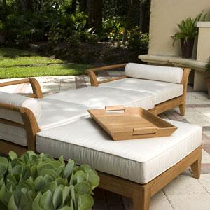 alt="17440TO Butler teak Serving Tray on Aman Dais Sectional with trees and fireplace in background"