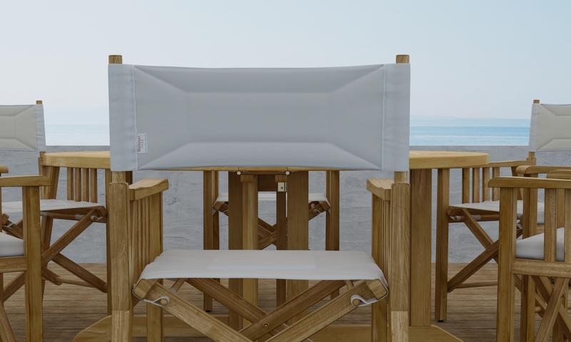 alt="70362 Barbuda Director Teak Dining Set Director Chair showing closeup of chair back on outdoor patio facing a white wall and ocean in background"
