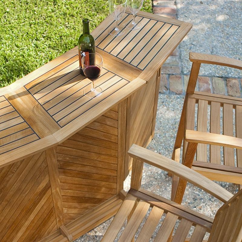 alt=" 70072 somerset teak bar and stool set opened with wine bottle and three wine glasses on concrete patio aerial angle view with grass and stone walkway in background  "