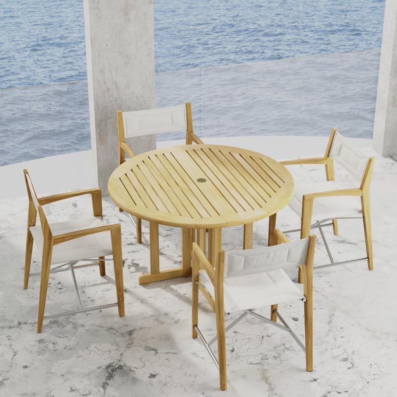 alt="70473 Odyssey Barbuda 5 piece Folding Dining Set of 4 folding director chairs and 48 inch round teak table on marble patio with the ocean in the background "