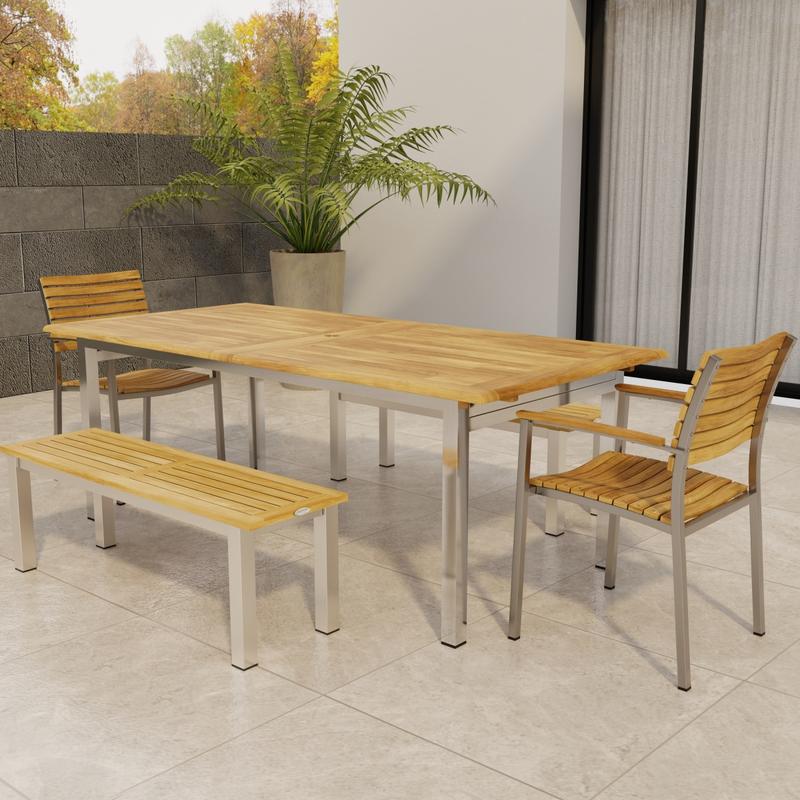 alt="70445 Vogue Bench Dining Set of Vogue stainless steel and teak Extension Table and 2 Dining Chairs and two 4 ft Backless Benches on tile with glass door of house and fence in back"