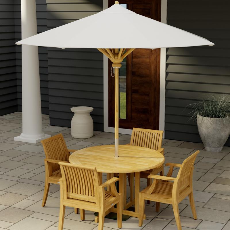 alt="70736 Barbuda Laguna Dining Set of Barbuda 4 ft Round Dining Table and 4 Laguna Arm Chairs with optional umbrella on patio with house and door and potted plant in the background"