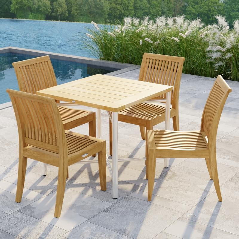 alt="70595 Odyssey Laguna Dining Set showing Odyssey Teak and 316L Stainless Steel 32 inch Square Dining Table and 4 Laguna Side Chairs on patio next to a pool with plants and waterview in background"