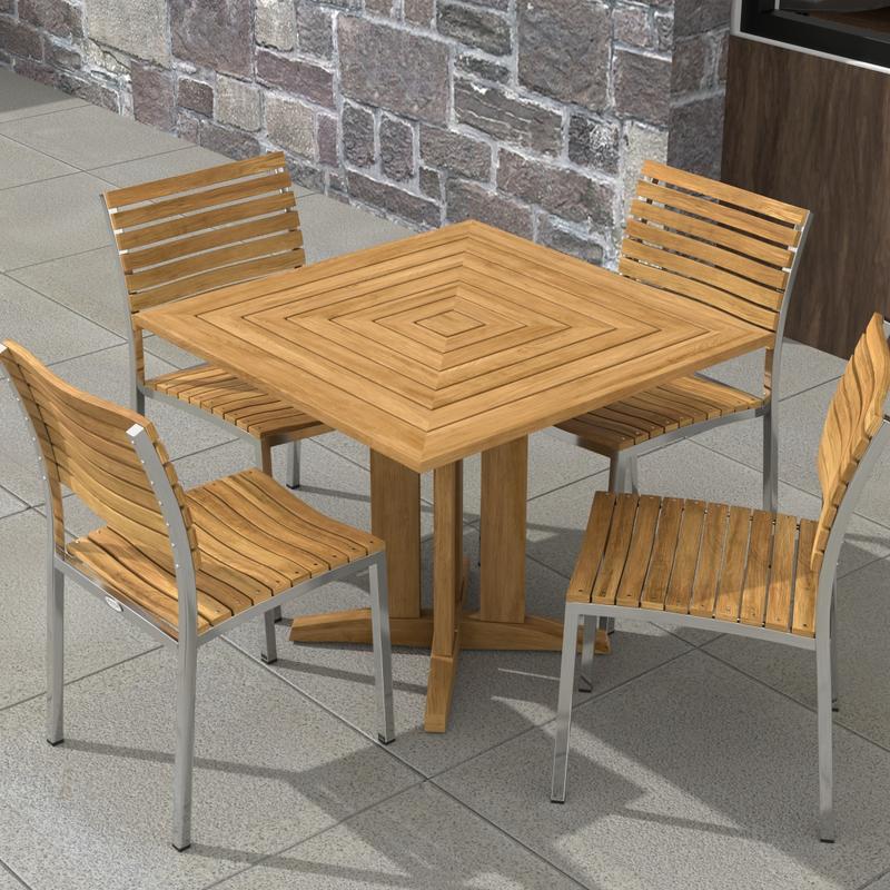alt="70574 Vogue Pyramid 5 pc Cafe Set of Pyramid Dining Table and 4 Vogue Side Chairs angled aerial view on tiled patio with stone wall and window in the background"