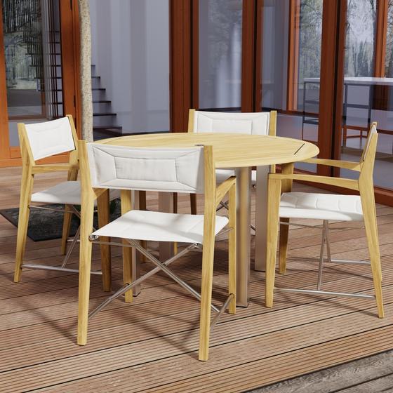 70619 Vogue Odyssey 5 pc Round Dining Set of Vogue Dining Table and 4 Odyssey Folding Chairs angled side view on patio with glass doors in the background 