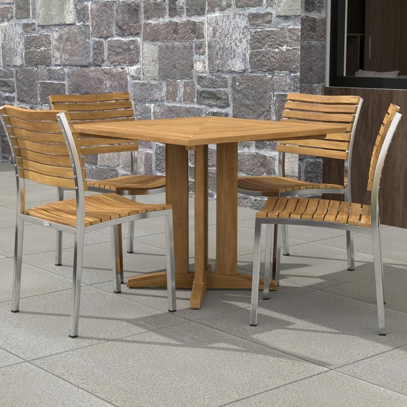 alt="70574 Vogue Pyramid 5 pc Cafe Set of Pyramid Dining Table and 4 Vogue Side Chairs on tiled patio with stone wall and window in the background"