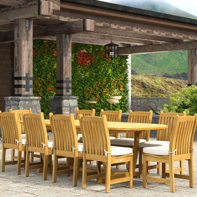 alt="70166 Montserrat Veranda 11pc Dining Set with optional cushions on patio in angled end view with pergola with hanging plants and vines and landscape plants and hillside in background"