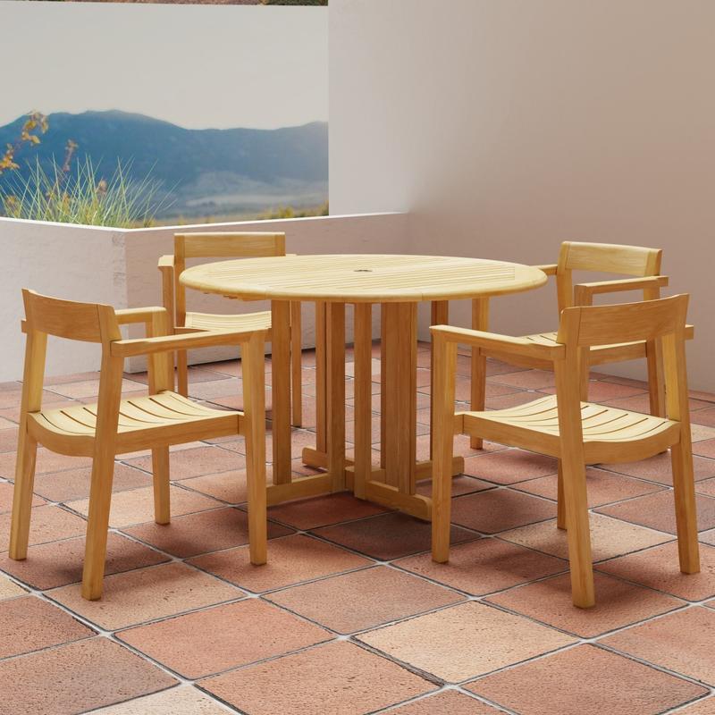 alt="70384 Barbuda Horizon Teak Dining Set of Barbuda 48" Round Folding Table and 4 Horizon Armchairs on tiled patio with house and ocean view and hills in background"