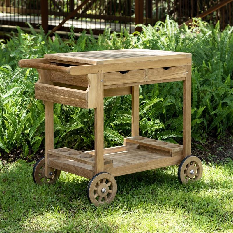 alt="image of 17105S Alicante teak Trolley Cart on grass with shrubs in background"