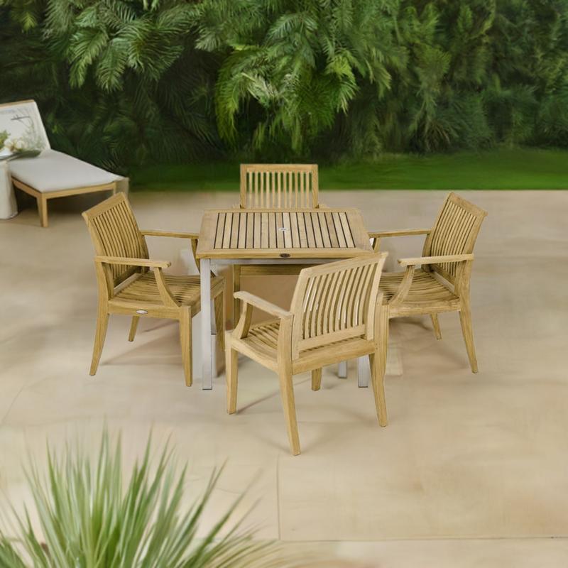alt="70603 Vogue Laguna 5 pc Dining Set of Vogue Teak 36 inch Square Table and 4 Laguna Dining Arm Chairs angled aerial view on patio with plants and white chaise in the background "