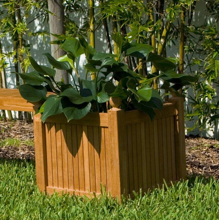 alt="18109 square planter box angled view on grass field with shrubs in background"