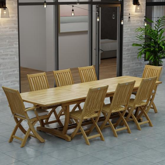 70794 Veranda Barbuda Teak 9 pc Dining Set of Grand Veranda Dining Table and 2 Barbuda Armchairs and 6 Side Chairs on a patio with patio lights and glass doors of house in background