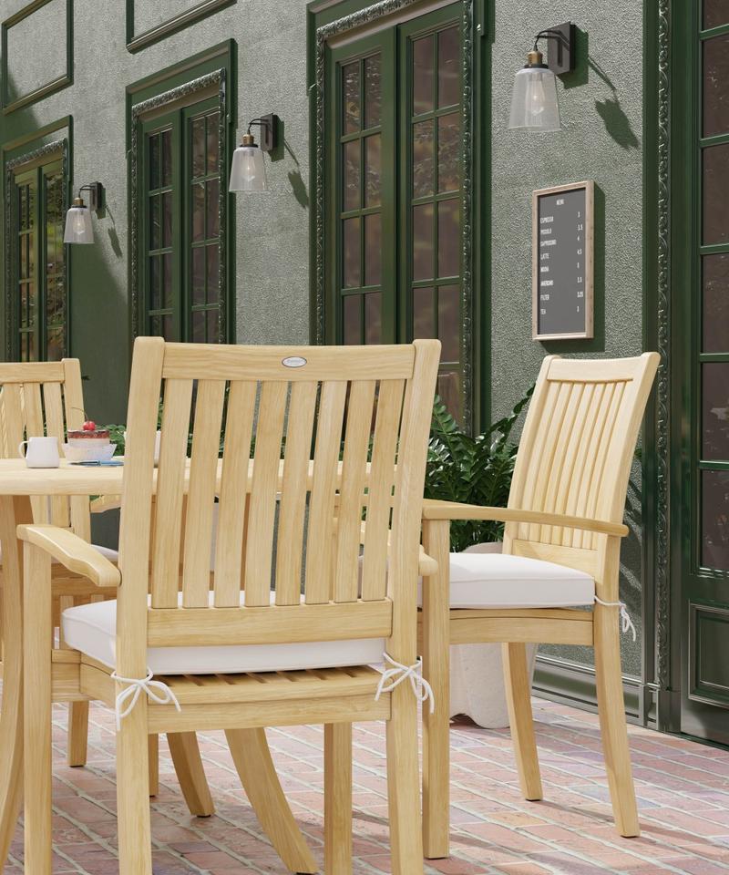 alt="70027 Grand Hyatt 5 pc Dining Set on brick patio showing closeup side view of 2 dining chairs with optional seat cushions outdoors with glass doors in background"