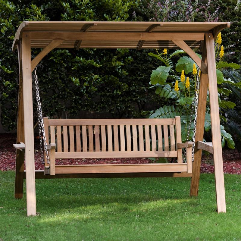 alt="13955 veranda swinging bench on grass with trees and shrubs in background"