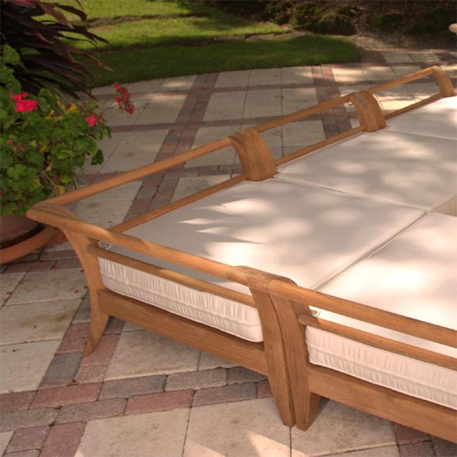 alt="72375MTO Aman Dais Corner Seat Cushion on Aman Dais Teak Corner Frame on paver patio with landscape plants and grass in background"