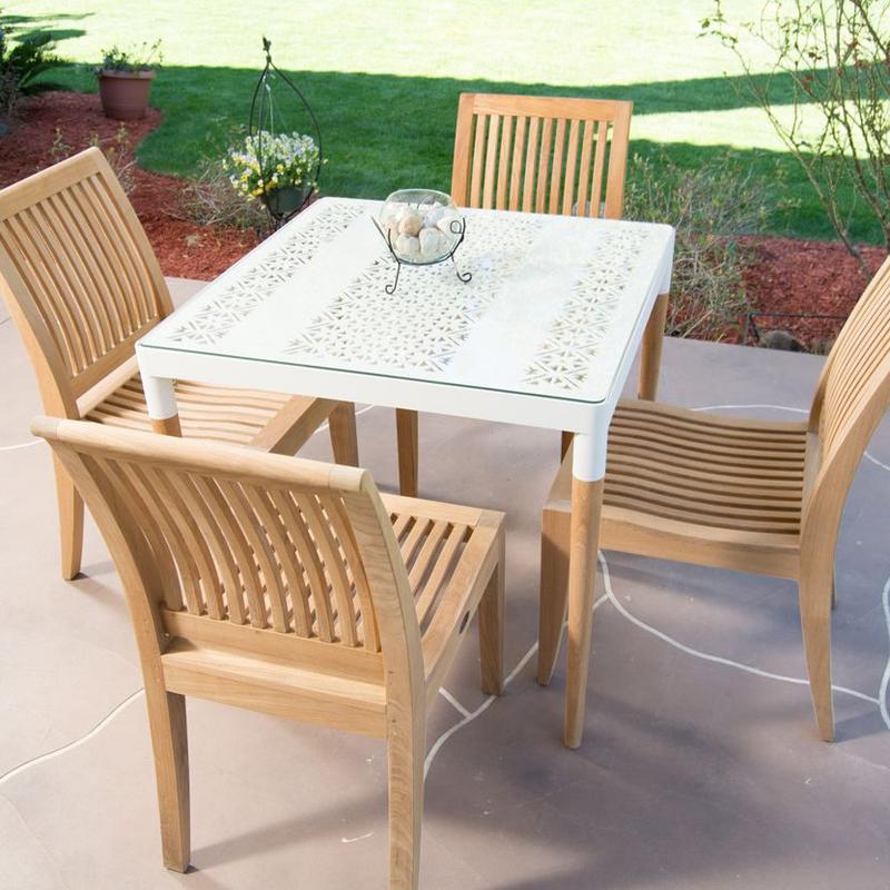 alt="70420 Bloom Laguna teak and powder coated aluminum 5 piece Dining Set of Bloom 32 inch square dining table with glass top and round vase and 4 teak dining chairs on paver patio"