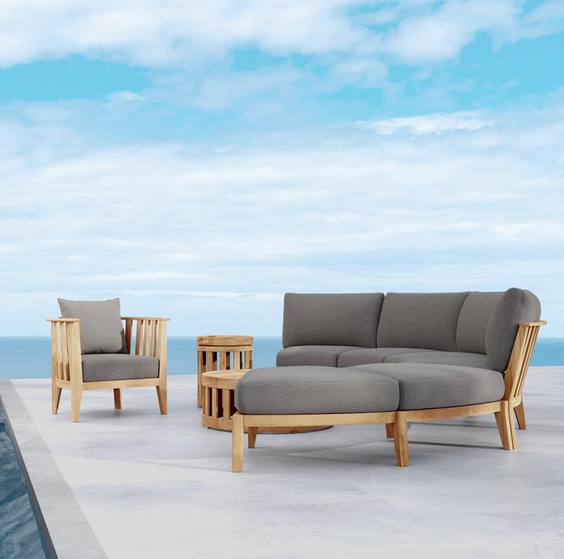 alt="70929 Kafelonia 6 piece Sofa Sectional Set side view on outdoor patio with ocean and blue sky in background"