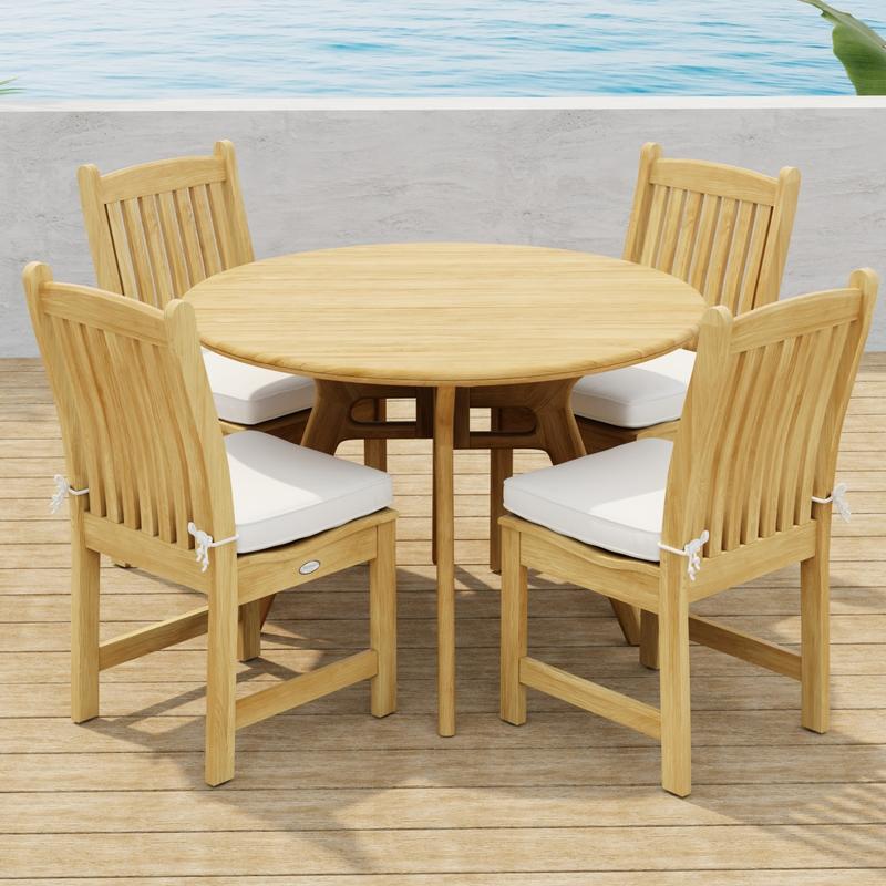 alt="70356 Veranda Surf 5 pc Cafe Dining Set showing a Surf 42 inch round dining table and 4 Veranda Side Chairs with optional seat cushions side angled view on wood deck with ocean background  "