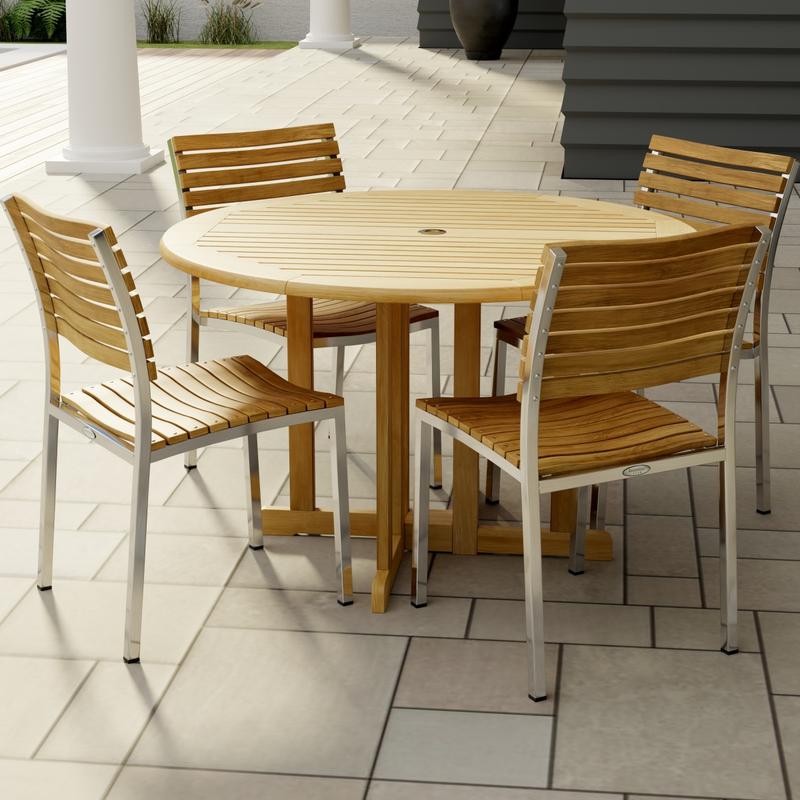 alt="70735 Barbuda Vogue 5 pc Teak DIning Set of Barbuda 48 inch Round Dining Table and 4 Vogue Teak and 304 Stainless Steel Side Chairs on tiled patio with partial columns and house in the background"