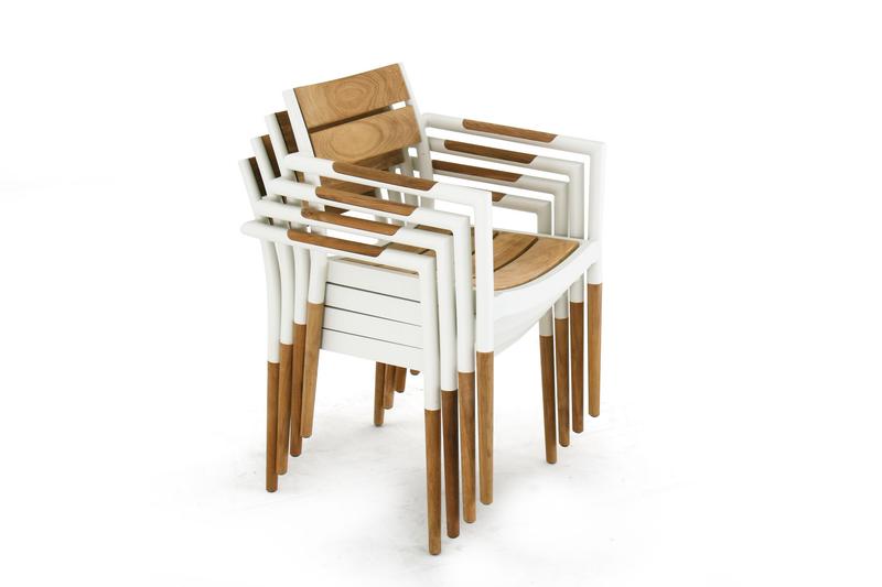 alt="70452 Bloom teak and powder coated aluminum stacking armchair in Marine finish stacked 4 high angled view on white background"