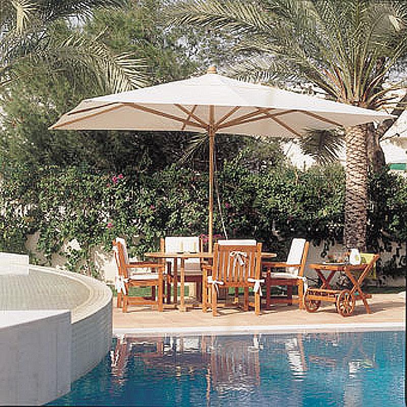 alt="17640 grand ten foot rectangular teak umbrella opened in dining set with cushions and serving cart on outdoor deck with pool view and palm trees and shrubs in background"